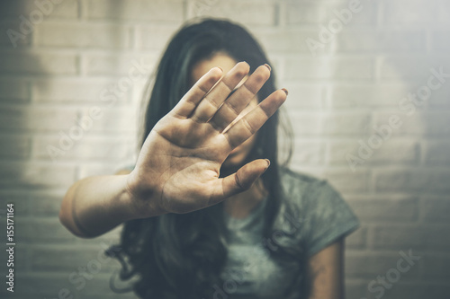 Young woman showing her denial with NO on her hand