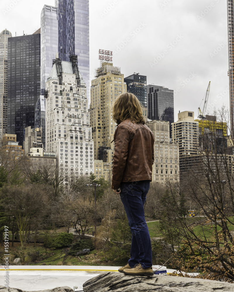 Caucasian Male In A Leather Jacket Looking At Manhattan Skyscrapers