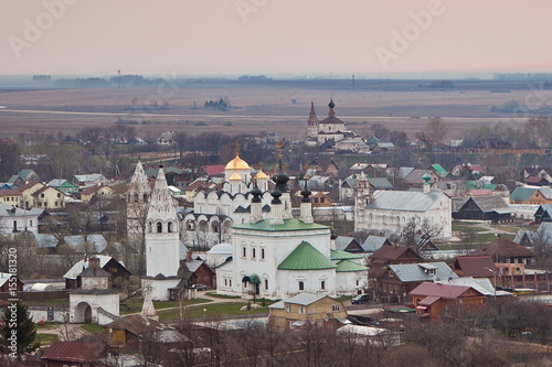 Evening old Suzdal cityscape from rooftop. Pokrovsky women's monastery and old houses