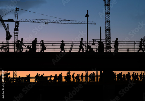 Photography silhouettes of people crossing bridge with sunset sky background