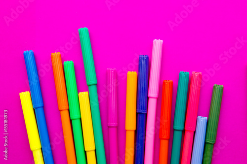 Art - colored pens on pink background
