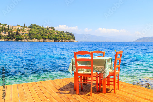 Table and chairs next to the beach in Corfu, Greece