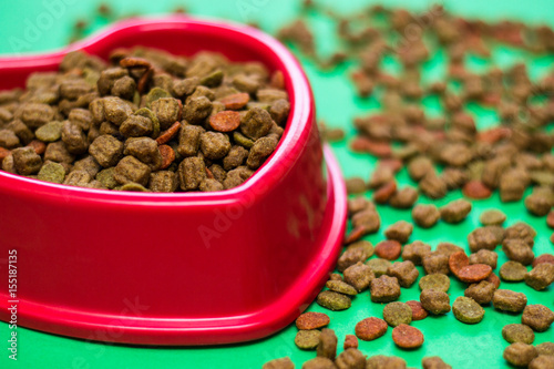 Red bowl full of multicolored dog food