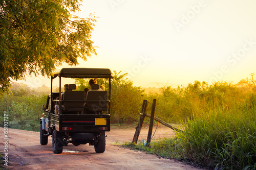 An open topped jeep carries tourists into the national park of Udawalawe, Sri Lanka to search for wildlife in the park. photo