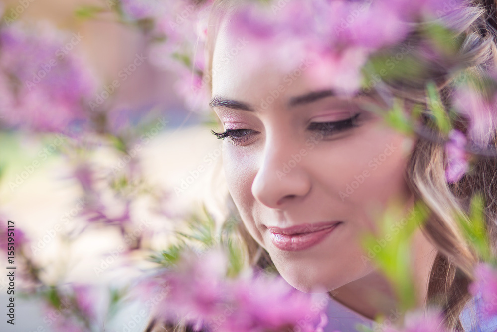 Fototapeta premium A girl in a blooming garden