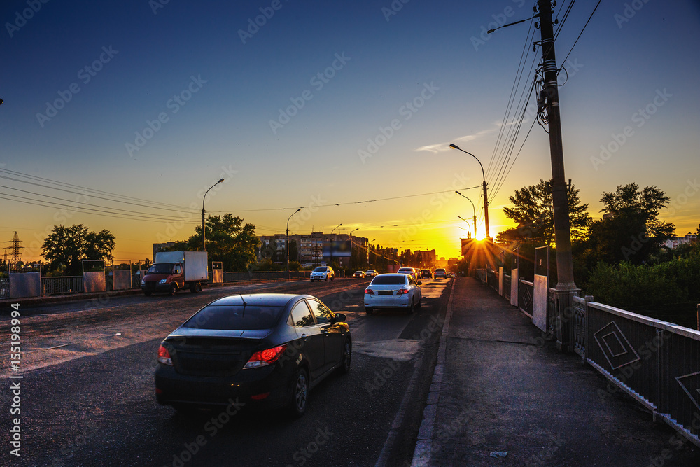 City traffic, cars on the bridge at sunset time, city life concept