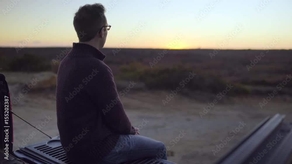 Man Sits In The Bed Of His Truck, Eats A Snack, Watches Sunset Over New England Moors Man Sits In The Bed Of His Truck, Eats A Snack, Watches Sunset Over New England Moors