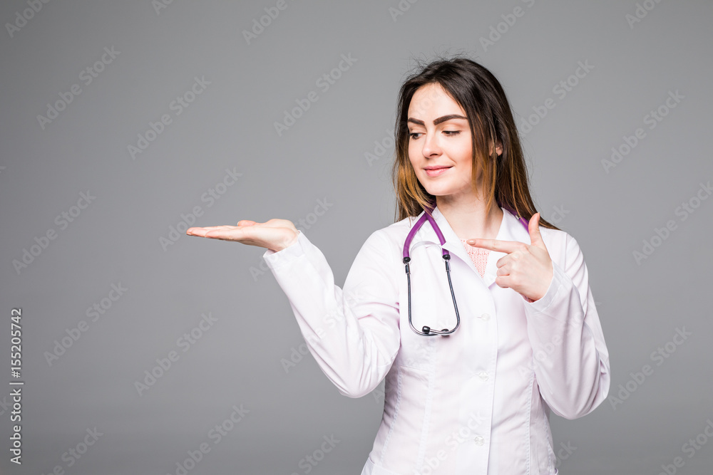 Female medical doctor showing copy space. Woman in white professional uniform with stethoscope on neck. Female medical doctor showing copy space. Woman in white professional uniform with stethoscope on neck.