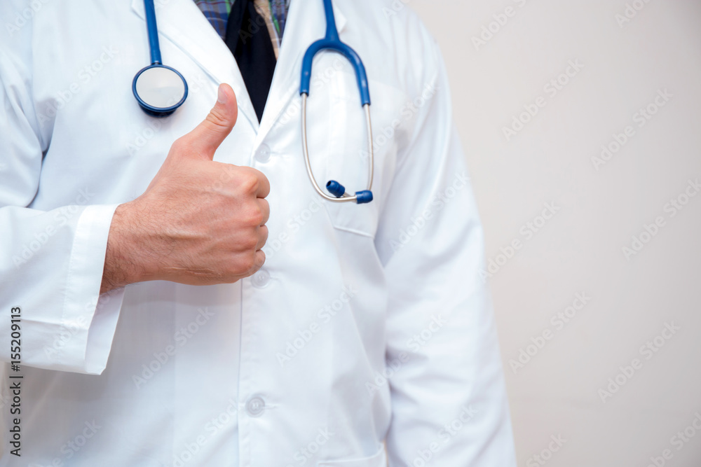 close up of male doctor hand showing thumbs up.