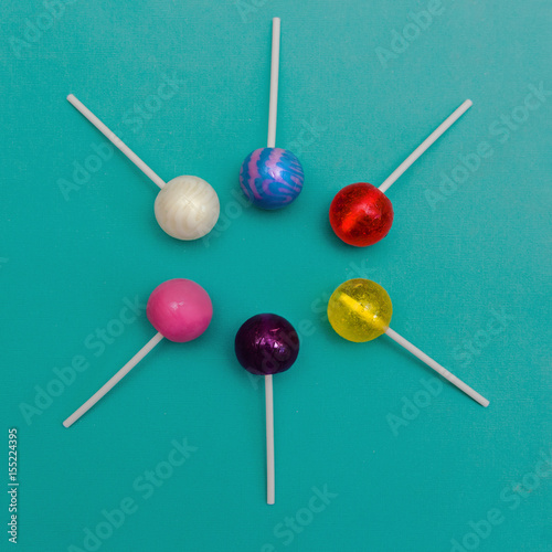 Lollipop Flat lay Minimal concept Six colorful round lollipops are lying on a light blue background One-color and two-color candies