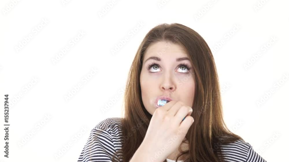 Woman dark long hair brushing cleaning teeth. Positive girl with toothbrush. Oral hygiene. Studio shot isolated on white background 4K ProRes HQ codec Woman dark long hair brushing cleaning teeth. Positive girl with toothbrush. Oral hygiene. Studio shot isolated on white background 4K ProRes HQ codec