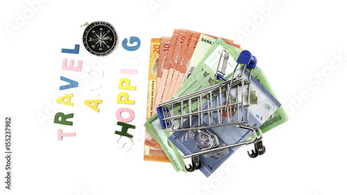 malaysian ringgit currency, supermarket carts and compass, concept of business and tourism.