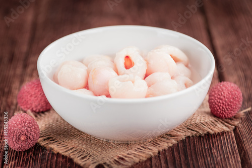 Wooden table with Preserved Lychees (selective focus)