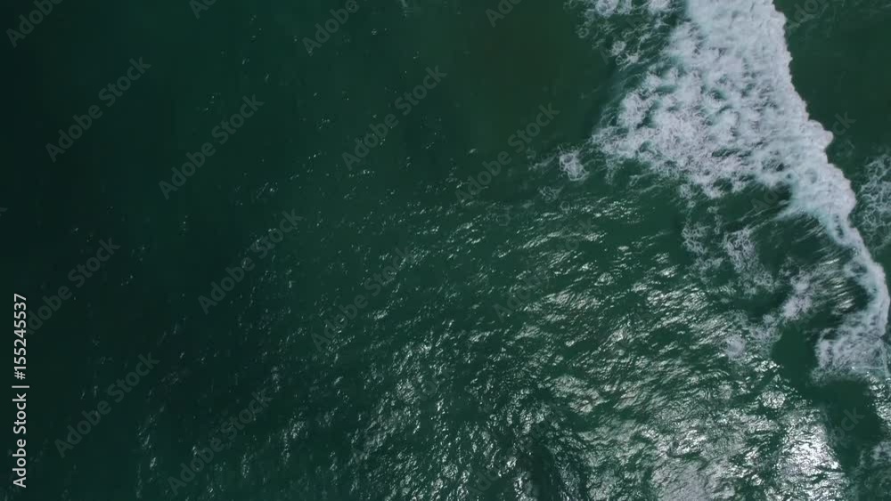 fly over the sea and waves breaking, people surfing, sunny day at the seaside fly over the sea and waves breaking, people surfing, sunny day at the seaside