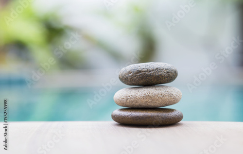 Beautiful natural zen stone over blurred nature background, selective focus on stone