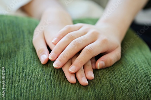 People sitting with hands clasped concept soft focus background