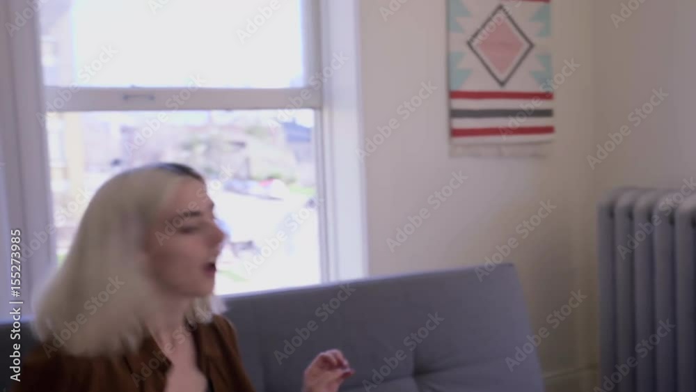 Couple Enter Their New Apartment With Armload Of Pillows And Boxes, Set Them Down In The Living Room, Have A Pillow Fight And Kiss Couple Enter Their New Apartment With Armload Of Pillows And Boxes, Set Them Down In The Living Room, Have A Pillow Fight And Kiss