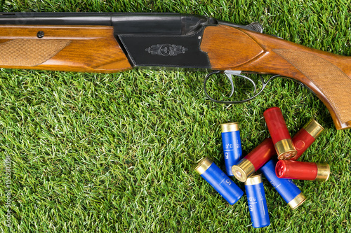 Hunting rifle and cartridges concept on the grass