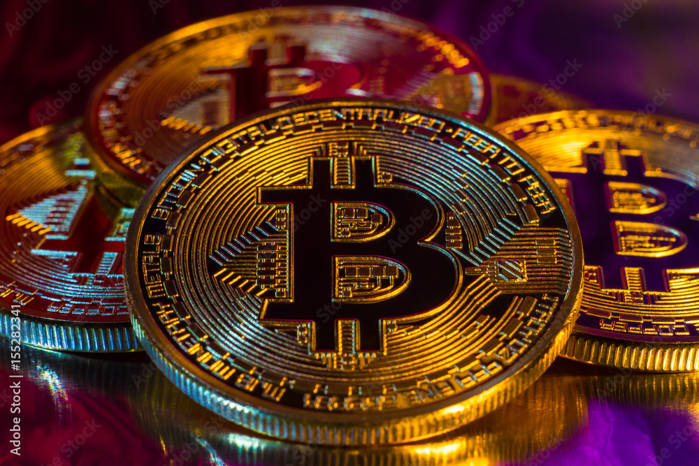 Cryptocurrency physical golden bitcoin coin on colorful background Cryptocurrency physical golden bitcoin coin on colorful background