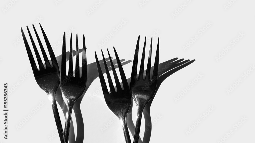 Fork and spoon in black and white / spoons are the primary utensil used for eating and forks are used to push foods Fork and spoon in black and white / spoons are the primary utensil used for eating and forks are used to push foods