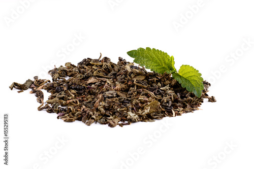 Green and black tea leaves on white background