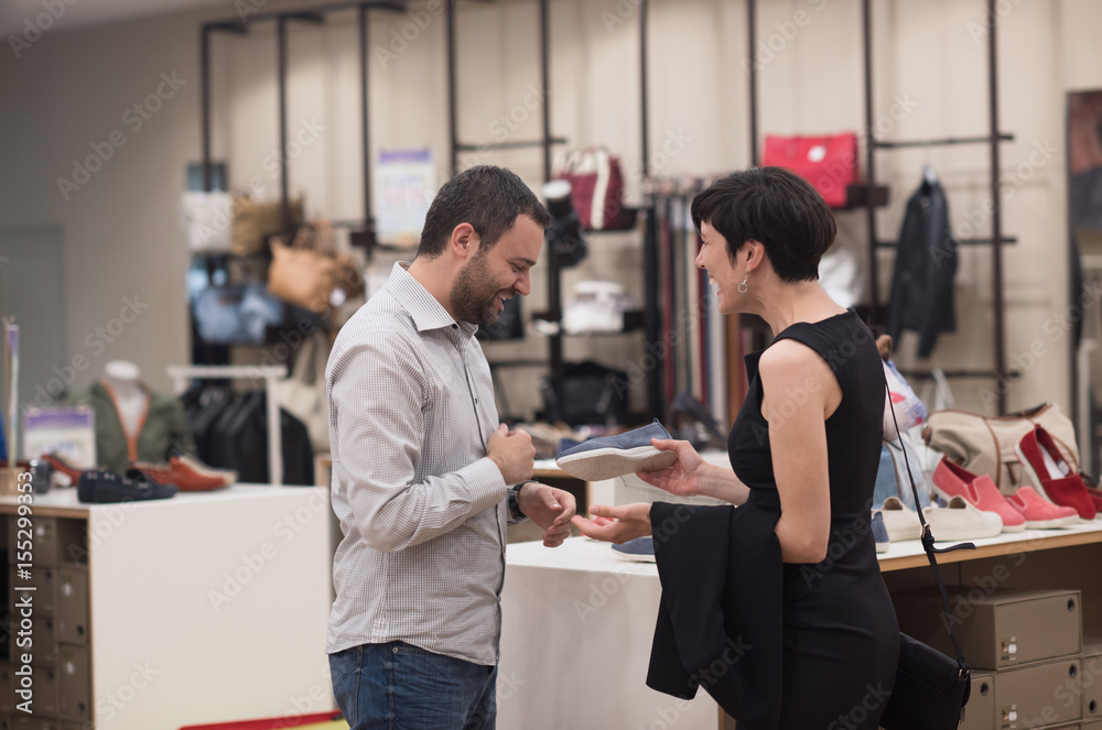 couple chooses shoes At Shoe Store