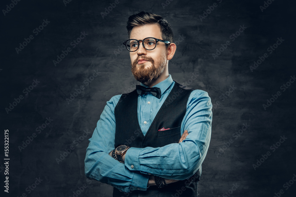 Successful bearded male with crossed arms, dressed in elegant shirt and waistcoat.