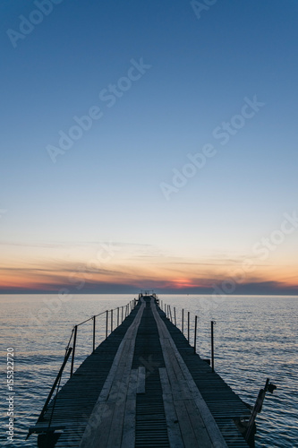 Vacation and Holiday concept - Wooden pier between sunset