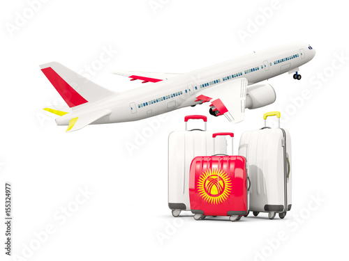 Luggage with flag of kyrgyzstan. Three bags with airplane © Mikhail Mishchenko
