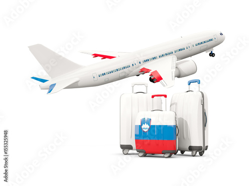 Luggage with flag of slovenia. Three bags with airplane