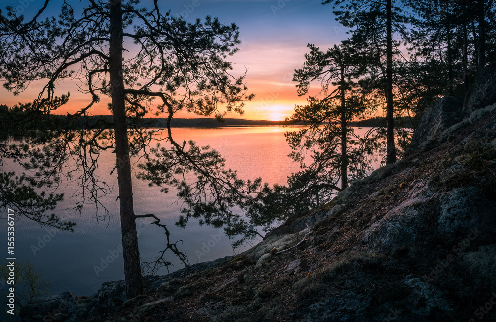 Scenic landscape over lake with sunset at spring evening in Finland