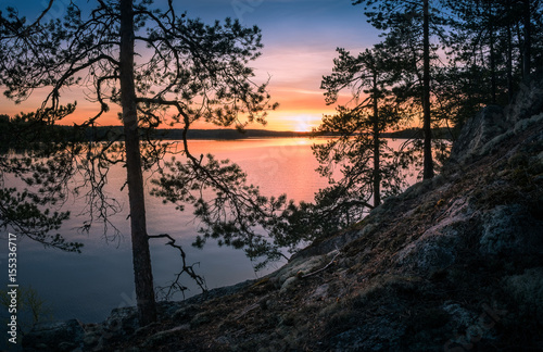 Scenic landscape over lake with sunset at spring evening in Finland © Jani Riekkinen