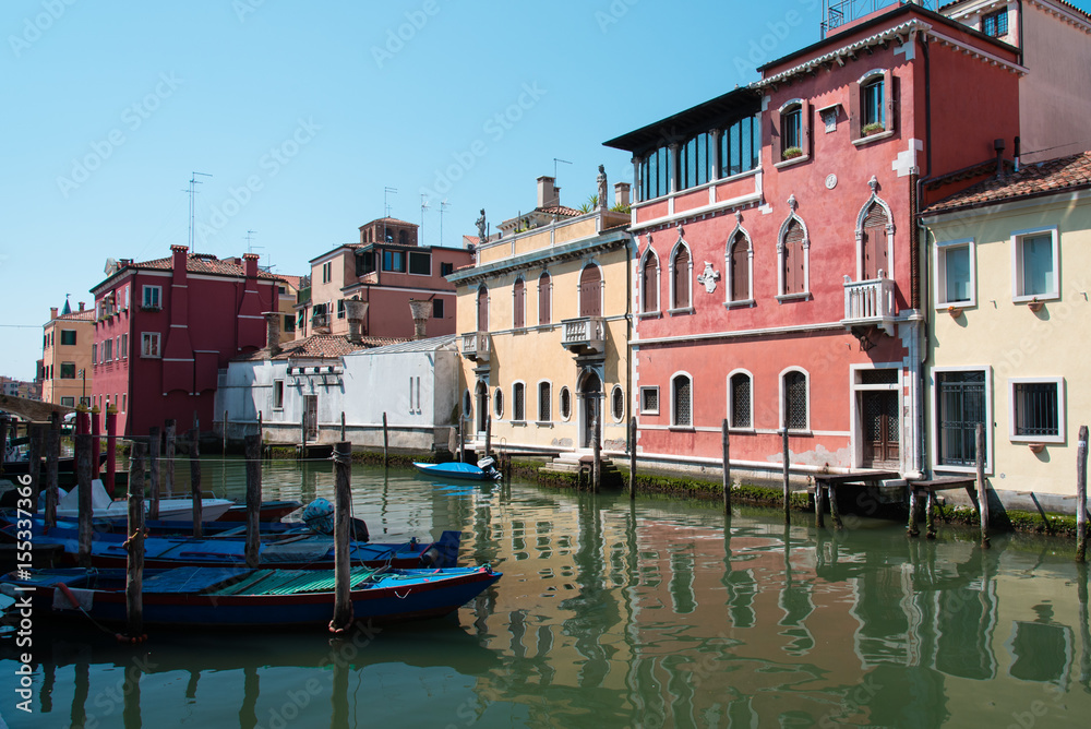 Obraz premium Reflections along the canals of Chioggia, Venice and its lagoon.
