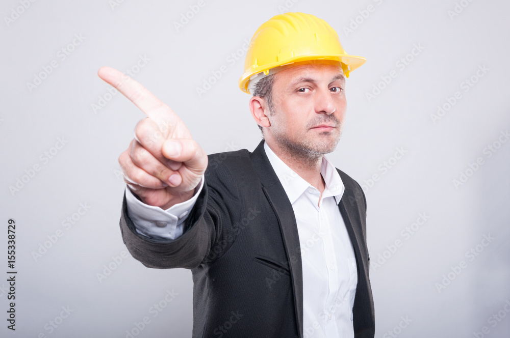Handsome contractor wearing helmet gesturing denial