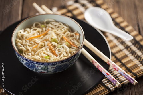 Asian soup with noodles in a decorated bowl