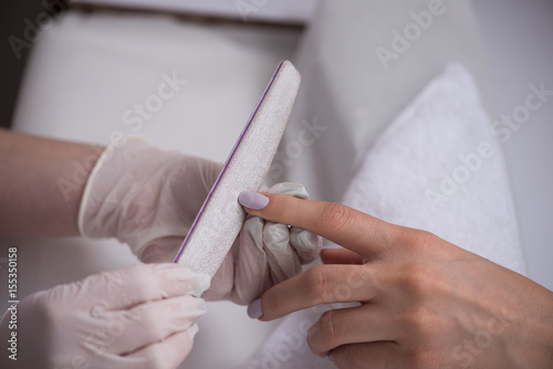 Woman hands receiving a manicure