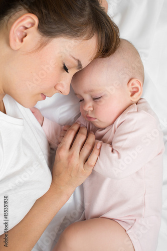 Mother with newborn baby sl...
