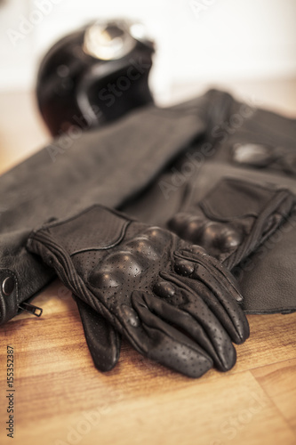 Motorcycle gloves, leather jacket and retro helmet