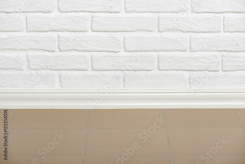 white brick wall with tiled floor closeup photo, abstract background photo