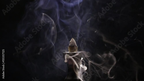 Aromatic cone smoldering in a ceramic stand