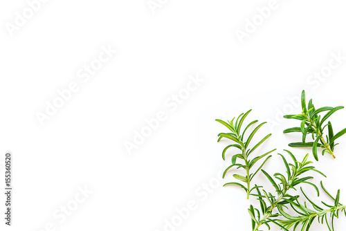 Fresh branches with leaves of organic rosemary seen from above isolated on a white background