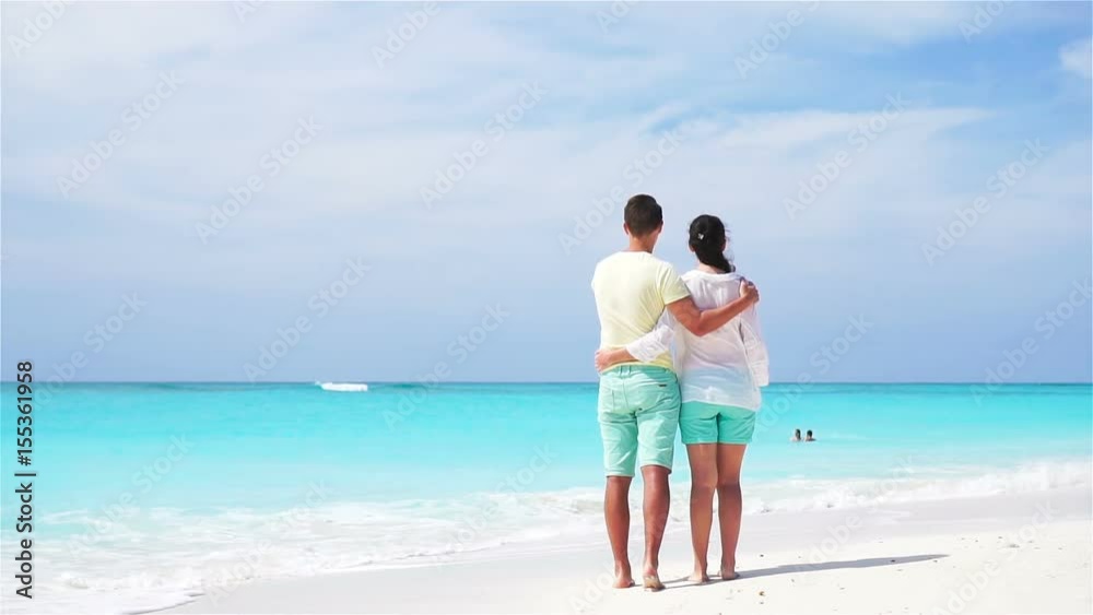 Young couple on white beach during summer vacation. Happy lovers enjoy their honeymoon. SLOW MOTION VIDEO. Young couple on white beach during summer vacation. Happy lovers enjoy their honeymoon. SLOW MOTION VIDEO.