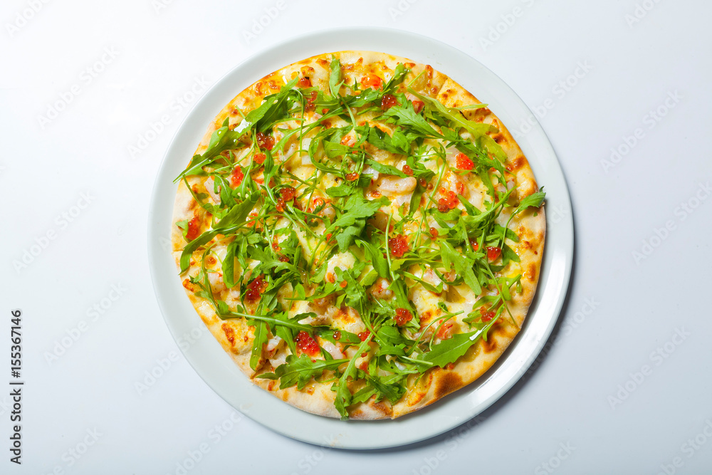 Pizza with seafood and arugula isolated on white Pizza with seafood and arugula isolated on white