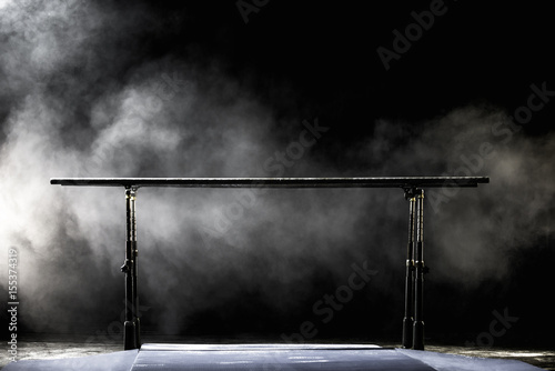 Konstfotografi Gymnastic parallel bars. Isolated on black background with fog,