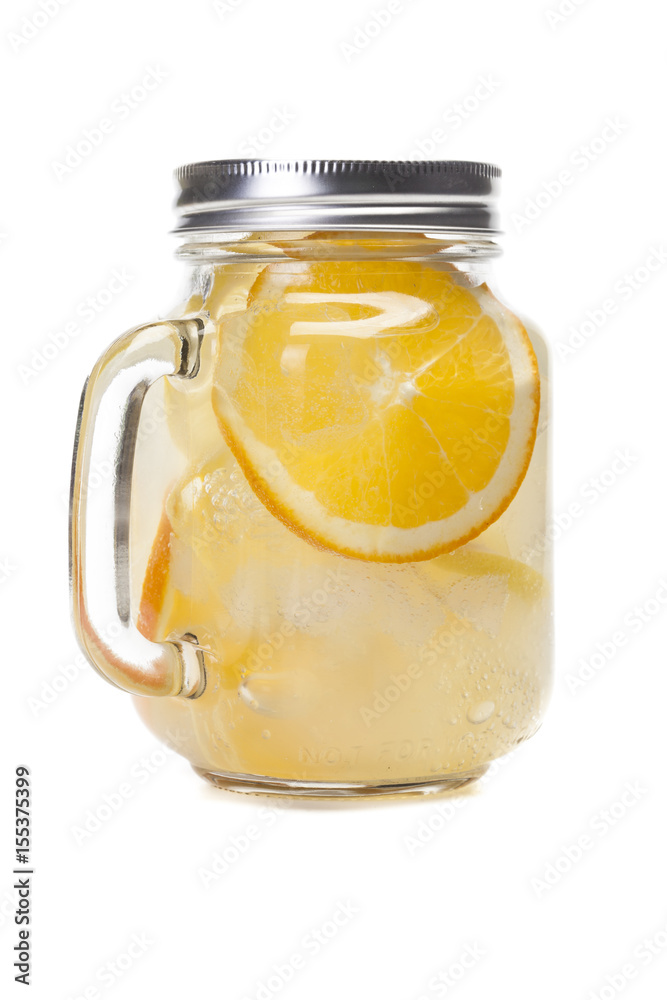 Lemonade in a mason jar with fruit slices isolated on white