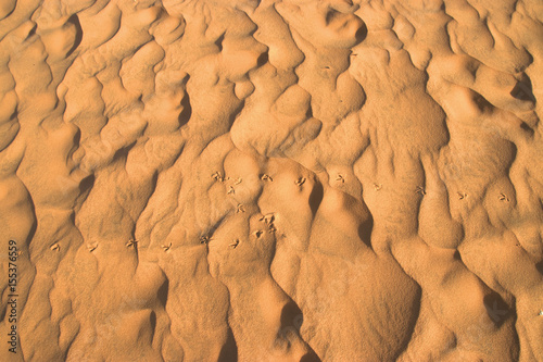 closeup of sand pattern and footprint of a beach in the summer.