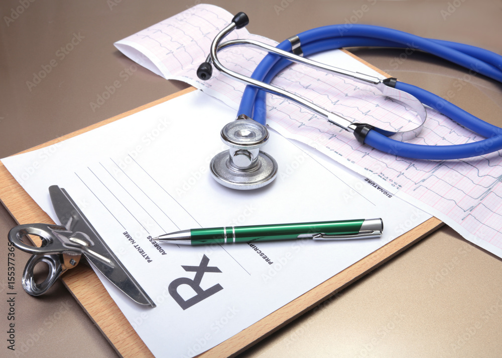 RX prescription, stethoscope and pen on white background.