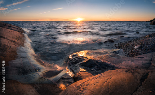 Scenic landscape with sunset and sea at summer evening in Finland