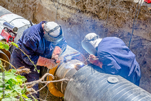 View on welding team of welders until them assembly a new pipeline
