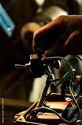 Repair of machine tools. Worker hands in workshop